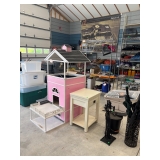 A deluxe pet house, a variety of empty tubs, and fireplace accessories.