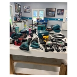 A variety of power tools including brands like Makita and Dewalt. 
