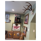 A dartboard and whitetail deer skull and more beer mirrors.