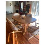 Mid - Century Dining Set with a Bow-end tabletop and four caster, swivel and tilt chairs