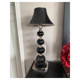 table lamp featuring stacked black glass spheres and a silver finish. 
