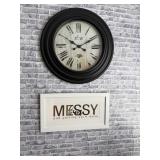 black wall clock featuring Roman numerals and a distressed white face