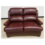 1222	HANCOCK & MOORE LEATHER LOVE SEAT W/BRASS TACK ACCENTS, SOME DISCOLORATION TO BACK TOP CUSHION, APPROXIMATELY 61 IN X 40 IN X 42 IN HIGH