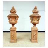 1151	OUTSTANDING PAIR OF TERRA COTTA URNS ON PEDESTALS WITH LIDS, EACH FLANKED WITH WINGED CHERUBS O