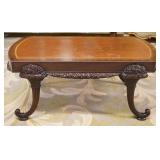 1176	UNUSUAL LEATHER TOP MAHOGANY COFFEE TABLE WITH CARVED CORNUCOPIA LEGS, APPROXIMATELY 42 IN X 23