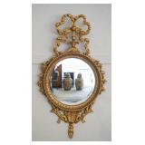 1182	ROUND BEVELED EDGE MIRROR IN FANCY GILT WOOD FRAME WIH RIBBON TWIST CREST. MADE BY THE MAJESTIC