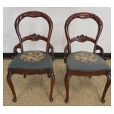 1203	PAIR OF WALNUT CARVED VICTORIAN CHAIRS WITH FLORAL NEEDLEPOINT SEATS