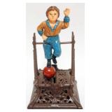 1098	BOOK OF KNOWLEDGE *BOY ON TRAPEZE* MECHANICAL BANK, MISSING BOTTOM COIN PLUG