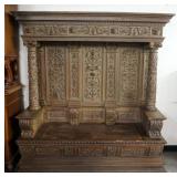 HEAVILY CARED HOODED CONTINENTIAL HALL BENCH WITH LIFT TOP SEAT. CARVED ALL OVER COLUMNS AND PANELS, APPROXIMATELY 71 IN X 21 IN X 75 IN H