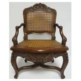 1049	MINIATURE DOLL SIZE CARVED WALNUT ARM CHAIR WITH HAND WOVEN CANE SEAT AND BACK, APPROXIMATELY 1
