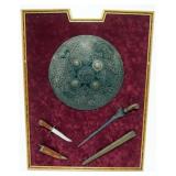 1130	FRAMED PERSIAN STYLE SHIELD AND KNIVES, FRAME APPROXIMATELY 26 IN X 34 IN H