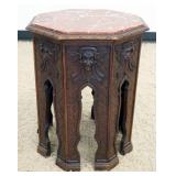 1157	WALNUT CARVED OCTAGON PEDESTAL TABLE WITH CARVED GRIFFIN HEADS ON EACH PANEL AND INSET BROWN MA
