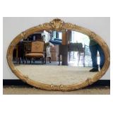 1165	OVAL WALL MIRROR IN REEDED GILT FINISH FRAME, APPROXIMATELY 51 IN X 36 IN