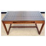 1192	MODERN STYLE DESK WITH LATTICE WORK AND GLASS TOP, AND 1 CENTER DRAWER, APPROXIMATELY 26 IN X 5