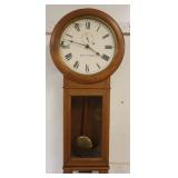 1229	SETH THOMAS WALL CLOCK IN OAK CASE, APPROXIMATELY 16 IN X 5 IN X34 IN, LOSS TO FACE
