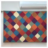 Colorful Quilted Wall Hanging | On a brass hanging rod, featuring a repeating pattern, finished with
