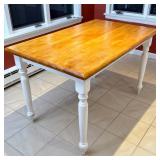 Farmhouse-Style Kitchen Table | A small kitchen dining table having a light wood top over carved whi