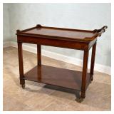 MAHOGANY TWO-TIER SERVING CART WITH TURNED HANDLE & BRASS CASTERS