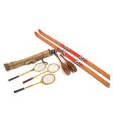 GROUP OF VINTAGE WOODEN SKIS, TENNIS RACKETS, GOLF CLUBS, AND INDIAN CLUBS | This assortment include