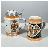 PAIR OF PLAYING CARD MOTIF CERAMIC BEER STEINS | Two ceramic beer steins decorated with polychrome p