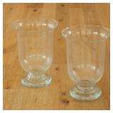 PAIR OF OVERSIZED GLASS FOOTED HURRICANE VASES | A pair of oversized hurricane vases constructed fro