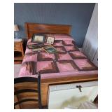 Queen size bed, pink and black comforter, pictures and assorted framed art, Metal trunk