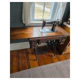 Vintage Singer treadle sewing machine inside wooden cabinet
