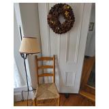 Vintage country ladder back chair with woven rush seat, wreath, floor lamp