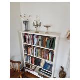 Book Case filled with books, Silver candy dish, Wooden bench, trinkets