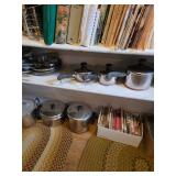 Open fry pans, cookbooks, stockpots with lids, pots with lids