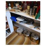 Open fry pans, cookbooks, stockpots with lids, pots with lids, carry case and casserole. flour sifte