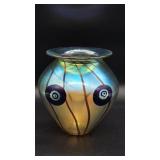 A signed iridescent art glass vase by Eischolt measuring 7 inches tall and 6.5 inches wide with appl