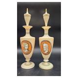  A pair of orange-ground ceramic urns with removable stoppers, each decorated with neoclassical port