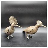 A pair of cast spelter metal birds with articulated wings, textured feathers, and curved beaks, each