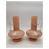 Pair of enameled peach satin glass ewers with hand-applied blue and white floral vines and ribbed de