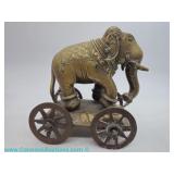 Handcrafted Indian brass elephant on wheels with engraved floral saddle and ornamental detail, belie