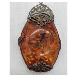 Baltic amber pendant with embedded insect in butterfly-mounted frame, likely produced in Eastern Eur