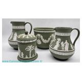 A group of four Wedgwood Jasperware pieces in the sage-green color, with an approximate height of 5 