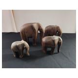  Four carved wooden elephant figurines; measures 3" Tallest
