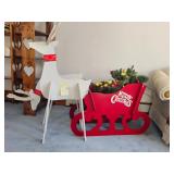 Wooden reindeer and sleigh with Christmas decorations; measures 35.5" x25" x17" x48" Tallest. Can be