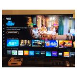 Vizio television. remote controls, VHS player and a DVD player. TV in working condition; measures 65