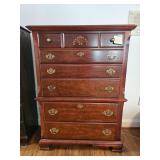 Wooden chest of drawers with brass handles and decorative carving; measures 52.5 x 38 x 18". Please 
