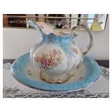 A vintage Warwick porcelain pitcher and basin set with floral design and blue accents; measures 12 x