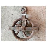 Rusty cast iron pulley with hook marked St. Louis