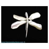 Sterling Silver tone dragonfly brooch with pearl wings and rhinestone body, measures 1.5" wide. Come