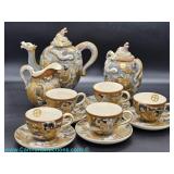 Japanese Satsuma dragonware tea set dating to the mid to late 20th century featuring a teapot with d