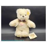 Steiff Mopsy Teddybär plush bear with ear tag and chest tag, accompanied by a Steiff Teddys booklet 