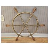 20th-century maritime-style brass ship’s wheel with a circular rim, tubular spokes, turned wooden ha