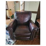 Bassett Upholstery traditional pushback recliner chair with dark brown leather upholstery, rolled ar