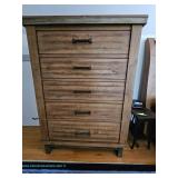 Wooden five-drawer chest of drawers with rustic finish and dark metal bar pulls; measures 40" x 19" 